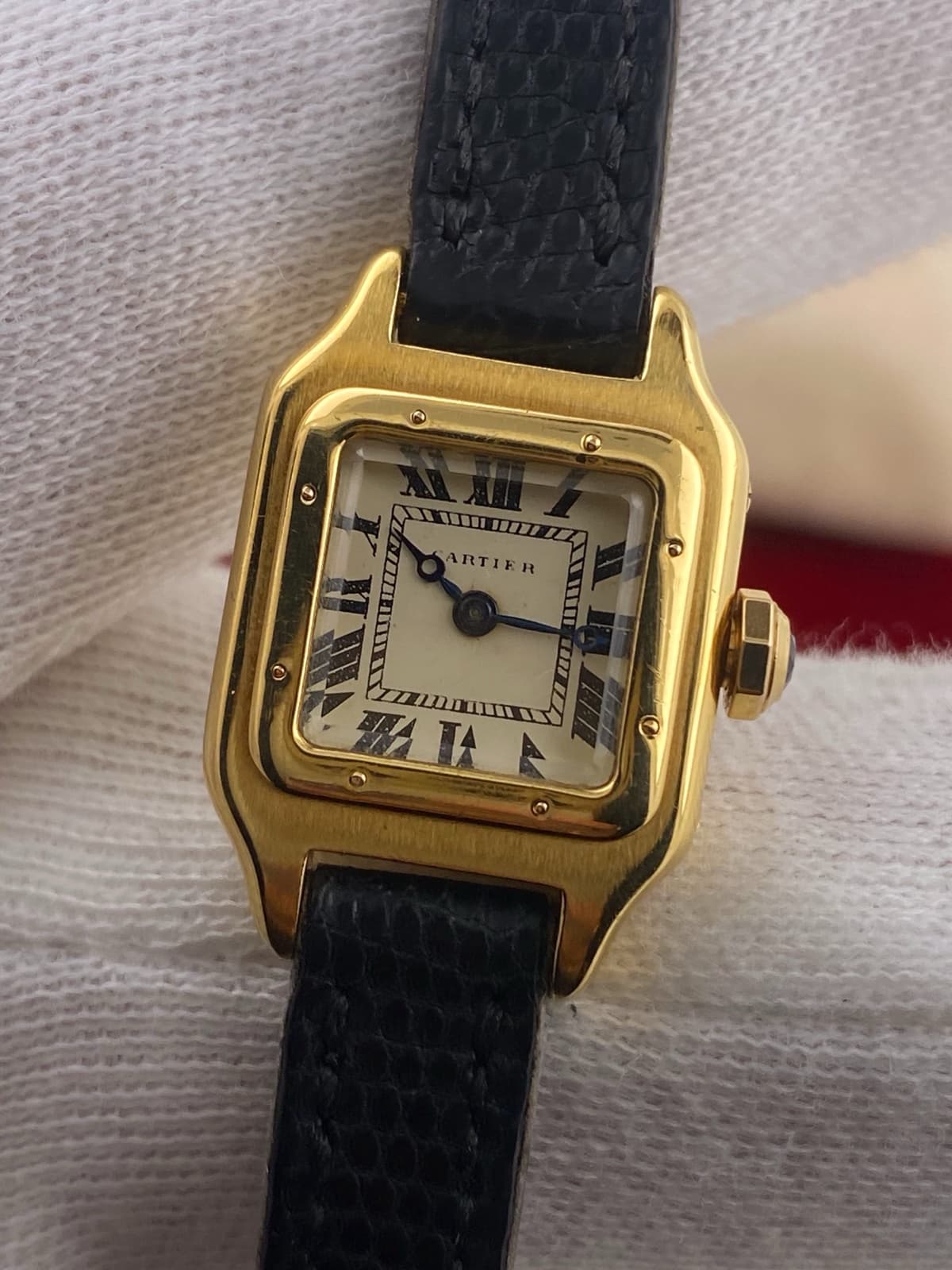 Cartier Santos Dumont from the late 1930s — square gold case with a screwed bezel, cream dial, Roman numerals and blued hands
